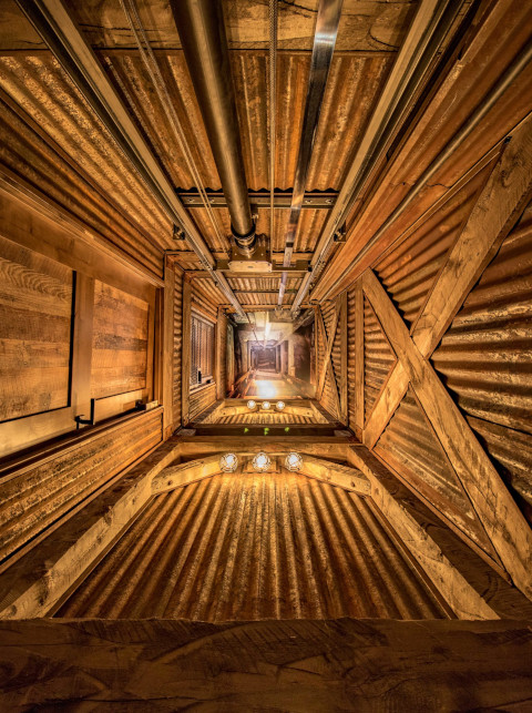 Long view down a mineshaft elevator.