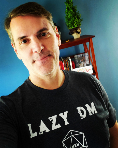 Man in a black tshirt that says Lazy DM.